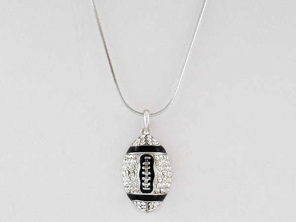 Crystal studded rhinestone football pendant necklace on silver chain.