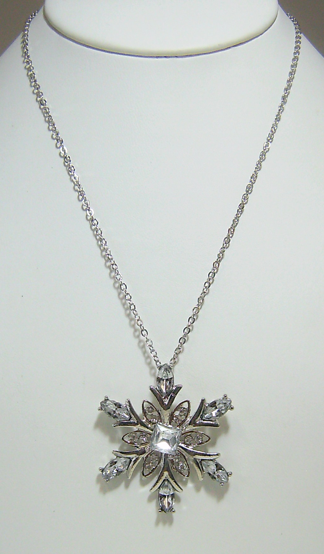 Silver snowflake rhinestone necklace with matching silver snowflake earrings.