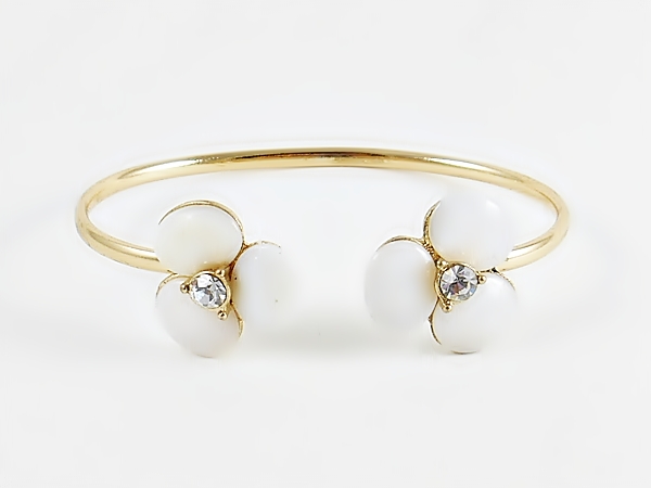 Pearly white shell stone flower mini cuff gold bracelet for a delicate, yet dramatic look. Each flower is accented in the center with a sparkly rhinestone for bling.