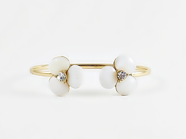 Pearly white shell stone flower mini cuff gold bracelet for a delicate, yet dramatic look. Each flower is accented in the center with a sparkly rhinestone for bling.