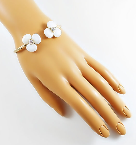 Pearly white shell stone flower mini cuff gold bracelet for a delicate, yet dramatic look. Each flower is accented in the center with a sparkly rhinestone for bling.