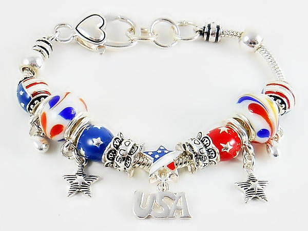 Silver snake chain charm bracelet with patriotic charm beads in red, white, blue and gold including dangle beads, large and small glass beads, and spacer beads.