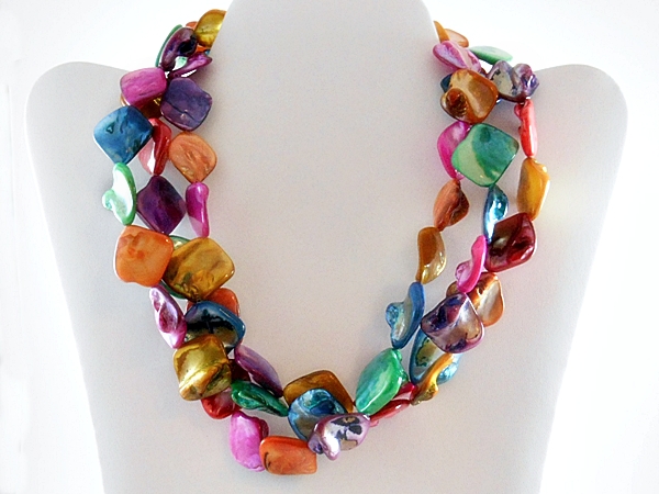 Three strands of vibrant rainbow multi color shells make up this unique necklace. The matching hook dangle earrings are made of the same pink and blue shells.