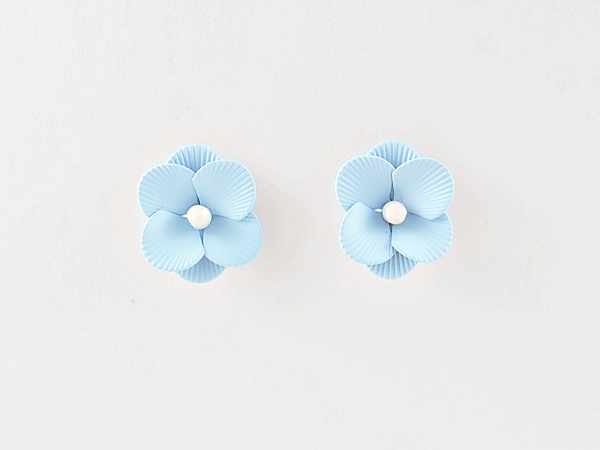Feminine and detailed sky blue epoxy metal flower post earrings with tiny white center.