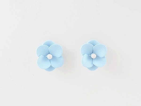 Feminine and detailed sky blue epoxy metal flower post earrings with tiny white center.