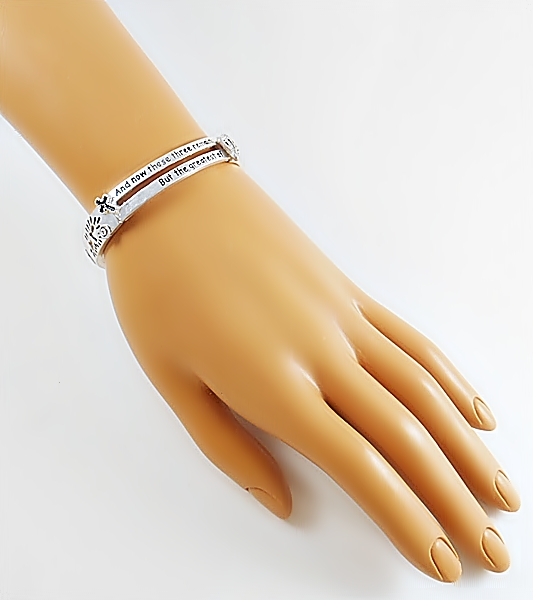 Bible verse Christian silver stretch bracelet with 1 Corinthians 13:13 features black lettering and accents including a heart, anchor and cross along with heart cutouts.
