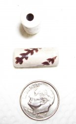 Thumbnail of Raku fired--about 20mm long tube, off-whie w/ chocolate design