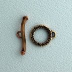 Thumbnail of SakiBrTog41 - Saki medium round bronze toggle w/squiggle bar - Thailand