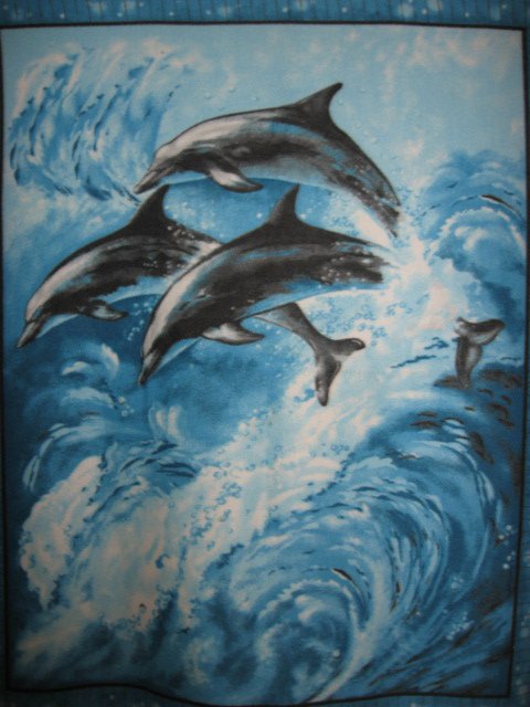 Image 0 of Dolphins in the ocean waves fleece blanket 