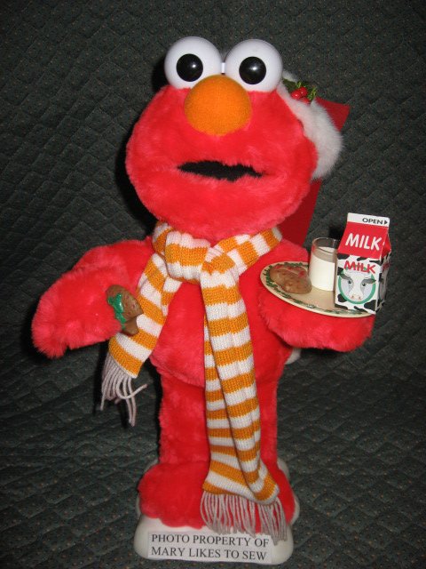 Elmo Santa motion doll with a plate of milk and Christmas cookies