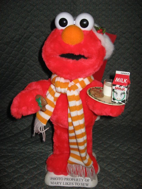 Image 0 of Elmo Santa motion doll with a plate of milk and Christmas cookies