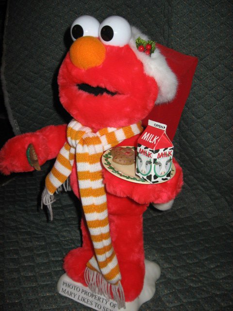 Image 1 of Elmo Santa motion doll with a plate of milk and Christmas cookies