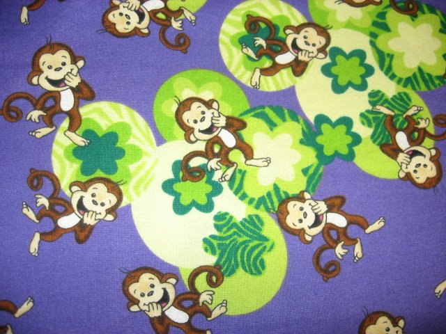 Happy Monkeys and flowers on a purple Flannel baby blanket 