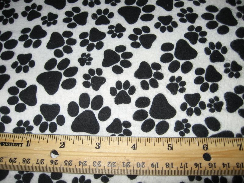 Image 0 of dog double flannel blanket black puppy paw prints