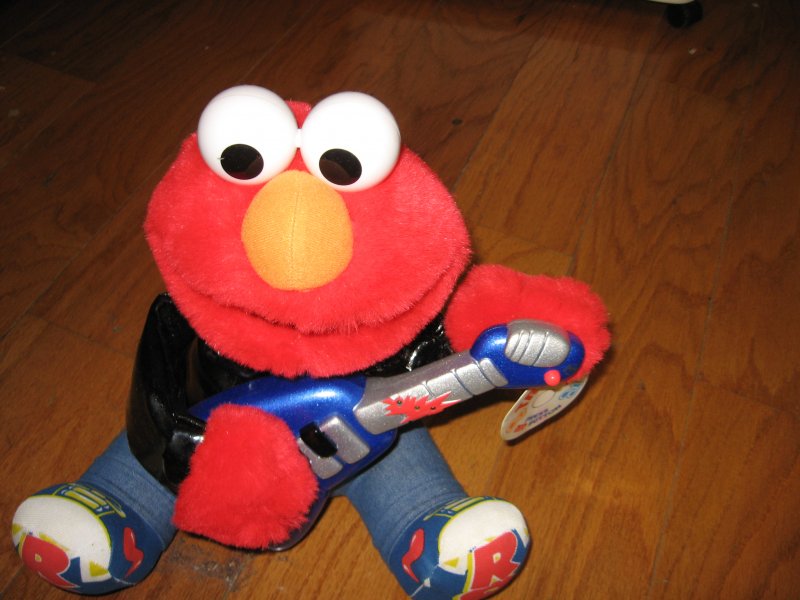 Image 0 of Elmo 1998 Rock and Roll plays guitar music vibrates