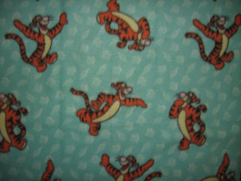 Tigger jumping around on a bluegreen soft  fleece baby blanket