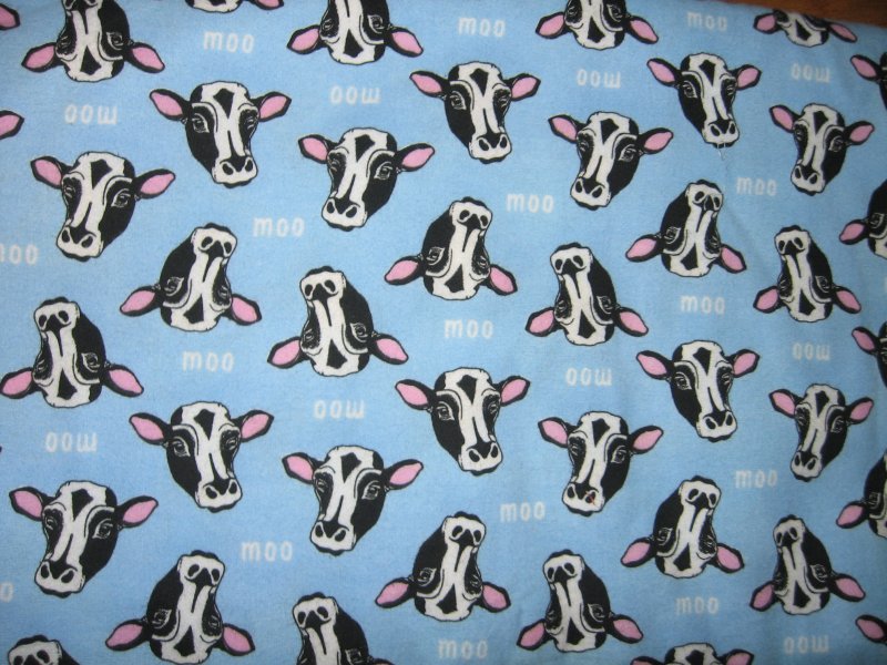 Image 0 of cow head face black and white  on powder blue flannel last yard