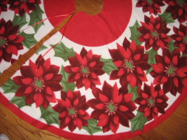 Image 1 of Poinsettia Fleece Christmas tree skirt finished surged edge satin tie
