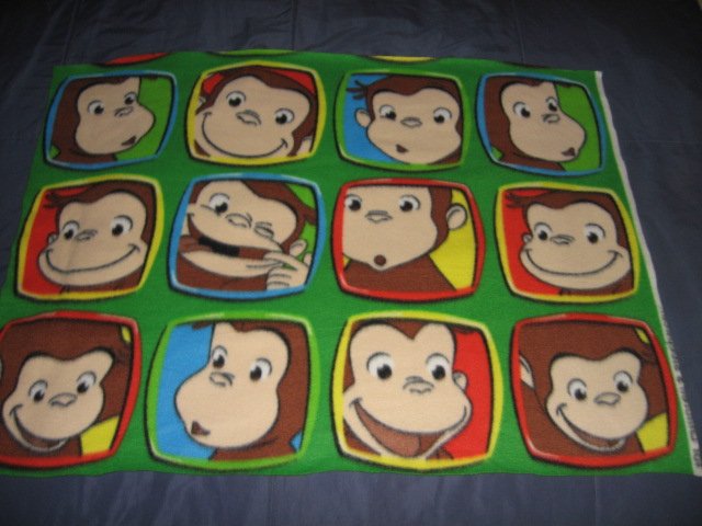 Image 0 of Curious George faces Licensed handmade baby or toddler fleece blanket 24