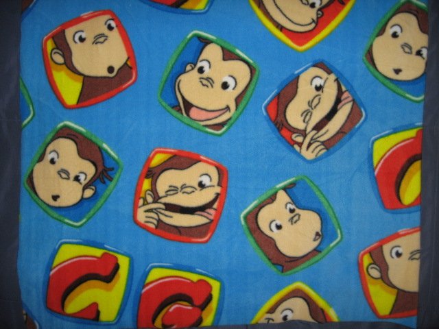 Image 0 of Curious George Faces fleece blue toddler blanket 30 inch by 36 inch