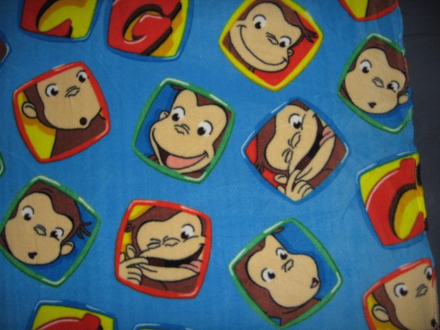 Image 1 of Curious George Faces fleece blue toddler blanket 30 inch by 36 inch