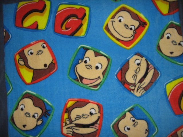 Image 2 of Curious George Faces fleece blue toddler blanket 30 inch by 36 inch