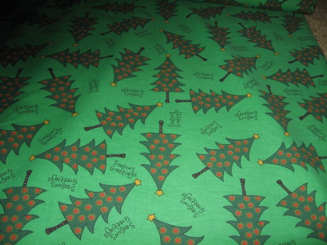 Christmas trees seasons greetings on green fabric by the yard