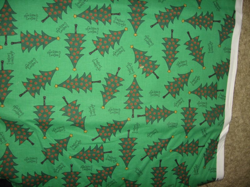 Image 1 of Christmas trees seasons greetings on green fabric by the yard