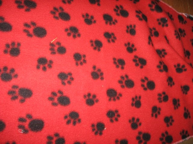 Image 0 of puppy paw prints colorful on small RED fleece for pets 