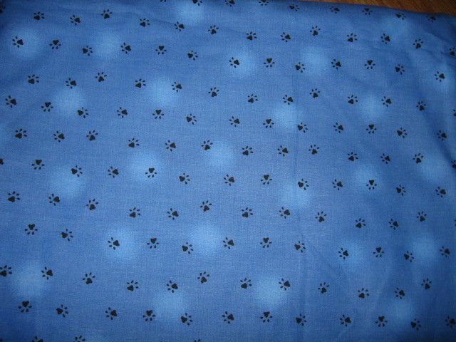 Black Paw Prints on blue cotton fabric 