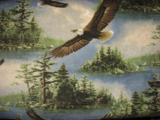 Eagles flying over lake and islands fleece blanket
