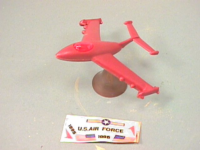 Balancing Red Plastic Jet Fighter Plane