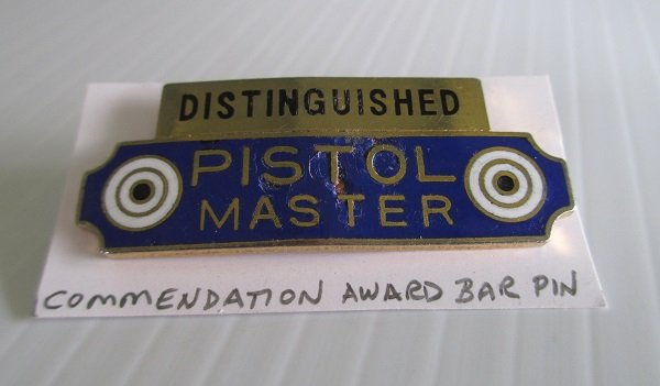 Distinguished Pistol Master Commendation Award Insignia bar worn on uniforms. 1.75 inches long with double clutch back holders. 