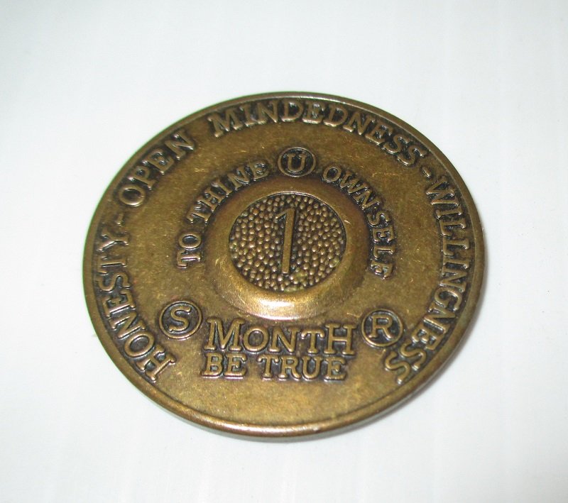 Achievement token for 1 month alcohol free living. Bronze in color. Back has the serenity prayer.  