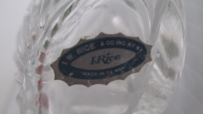 4.25 inch tall perfume bottle with I.W. Rice sticker on bottom. Frosted ground glass heart shaped stopper.  Unknown date. The bottle is empty.