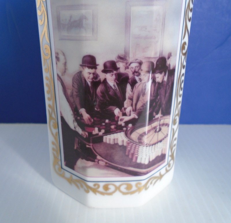 Nonagon shape white milk glass bottle from Cyrus Noble. Features the Tonopah Saloon of the 1870s. Photo with description of gambling scene.