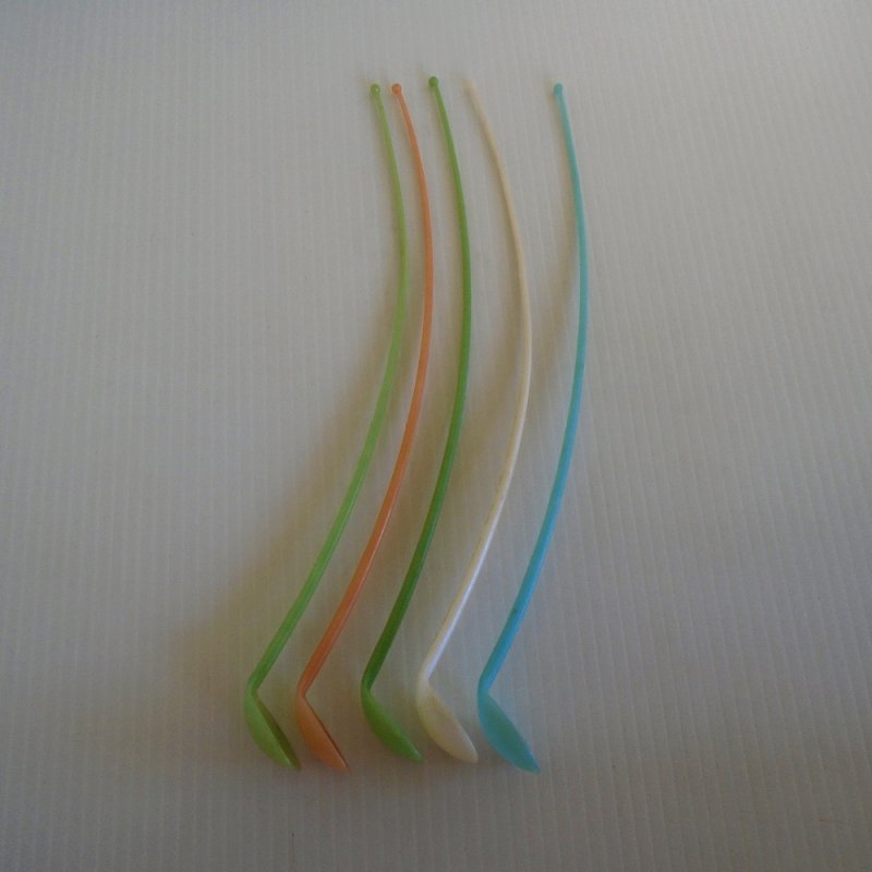 12 inch long Tupperware ice tea spoons. Each marked with the word Tupperware and the date 1954. 5 pieces in pastel colors. Estate purchase.