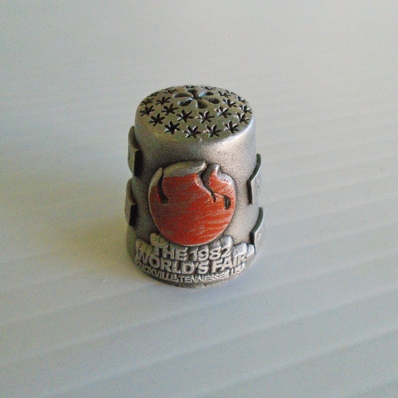 World's Fair 1982 Knoxville Tennessee pewter thimble. Has flags of some participating nations. One inch, signed Nicholas Gish.  