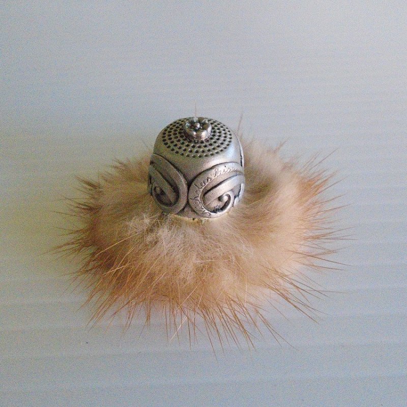 Nicholas Gish pewter thimble of a hat with a fir brim. Stands one inch tall. Signed on one side. Unknown age, purchased at an estate sale.  