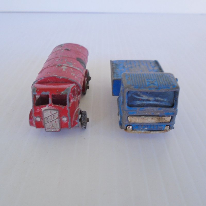 Two 1960s vehicles from Lesney Matchbox. Petrol Tanker number 11 and Site Hut Truck number 60. Old and well played with.