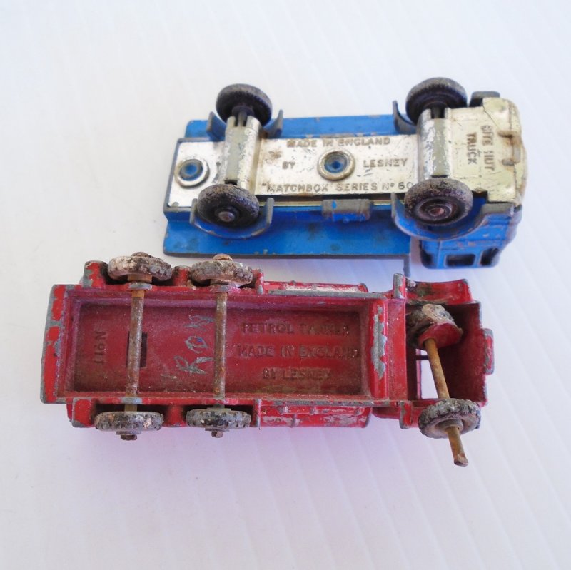 Two 1960s vehicles from Lesney Matchbox. Petrol Tanker number 11 and Site Hut Truck number 60. Old and well played with.