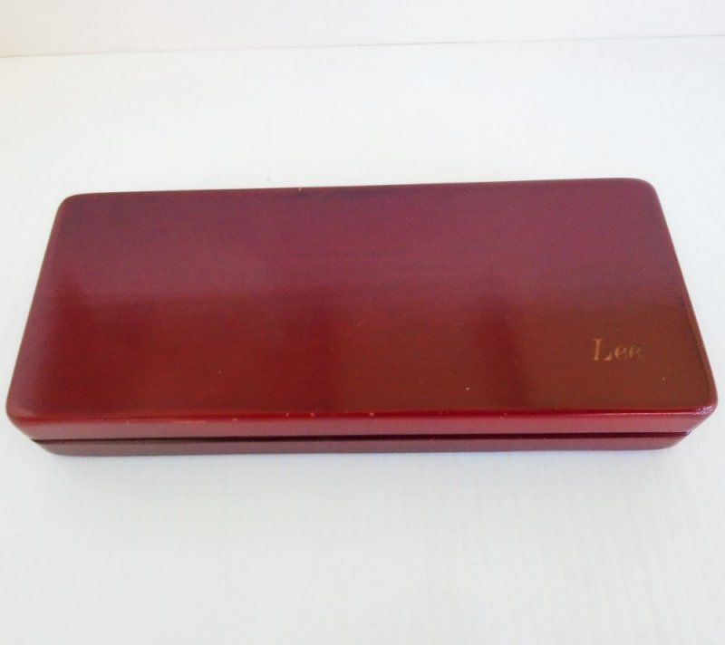 Vintage 1960s desk set consisting of a pen and letter opener, silver in color. Housed in a cherry wood box. Complete set is in excellent condition.