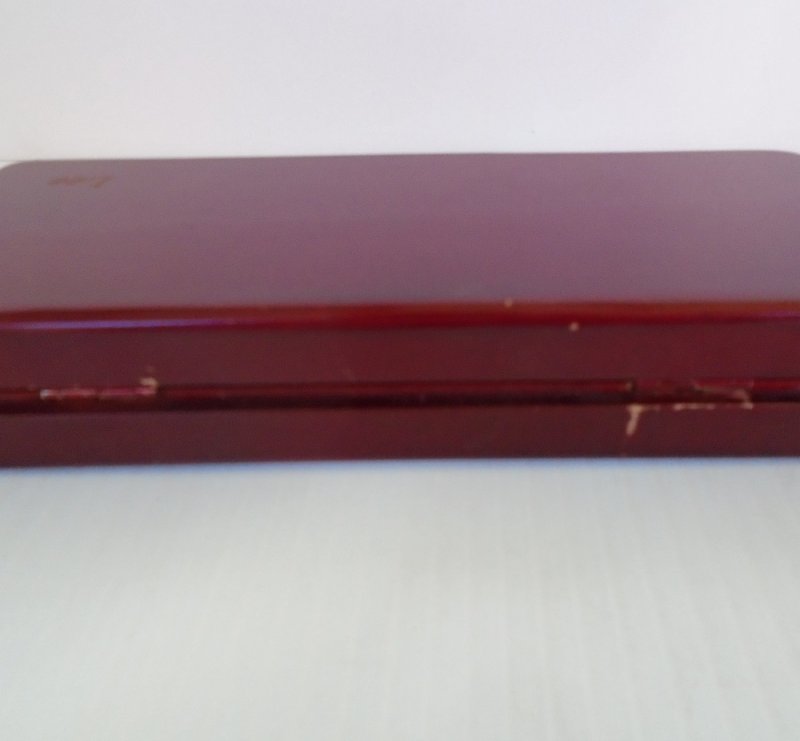 Vintage 1960s desk set consisting of a pen and letter opener, silver in color. Housed in a cherry wood box. Complete set is in excellent condition.