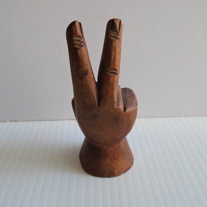 Hand carved peace sign hand. 4.5 inches tall. Dark brown in color. Unknown type of wood. Estate purchase.