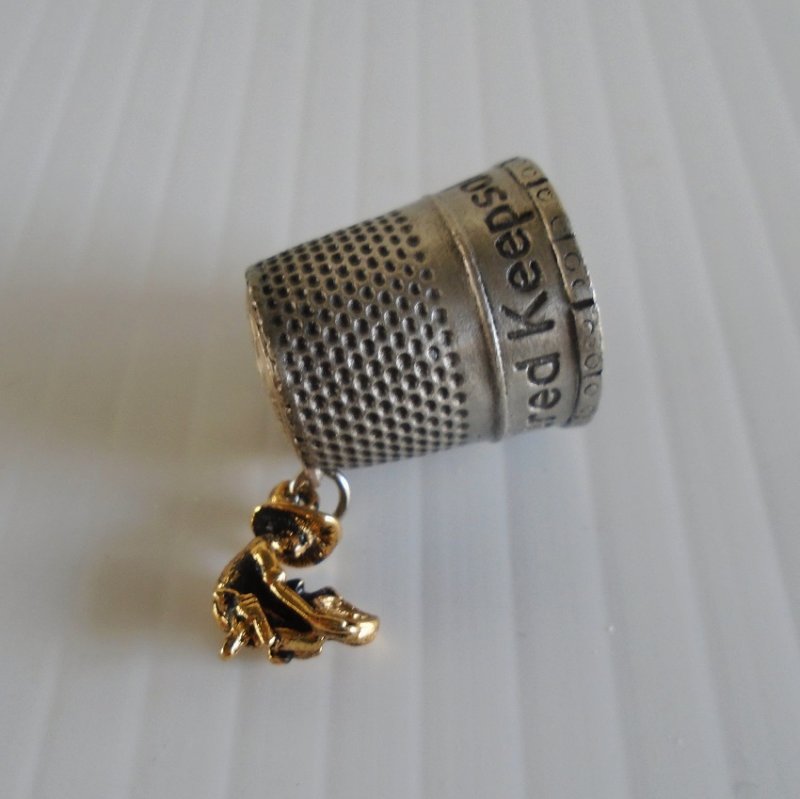 Thimble from Virginia City Nevada featuring a gold miner and his burro. 