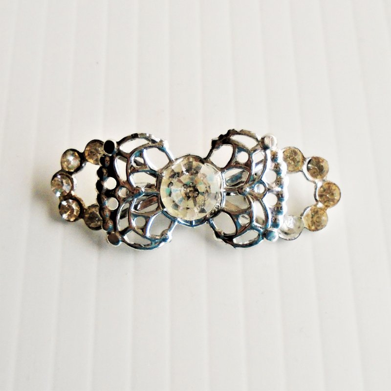 Rhinestone pin brooch. Bow type design, 1.75 by 3/4 inch. Estate find.