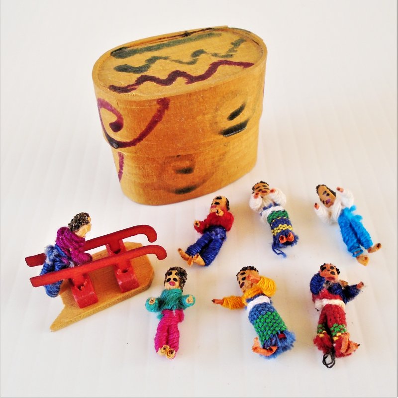 Collection of seven little people playing with a sled. About one inch tall. Made in Guatemala. Estate purchase.