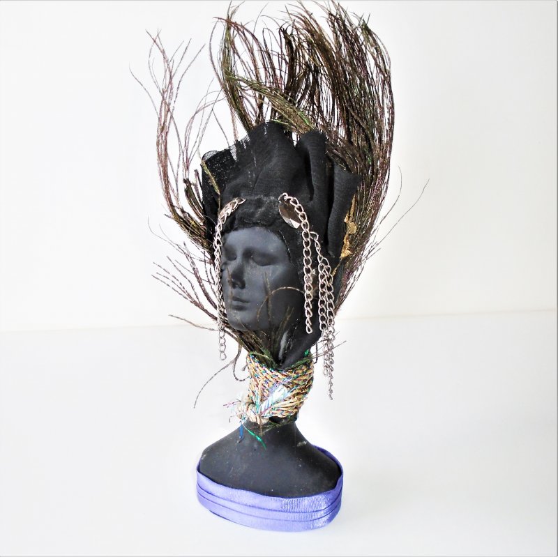 Bust of African American Black Lady with feathers on her head.