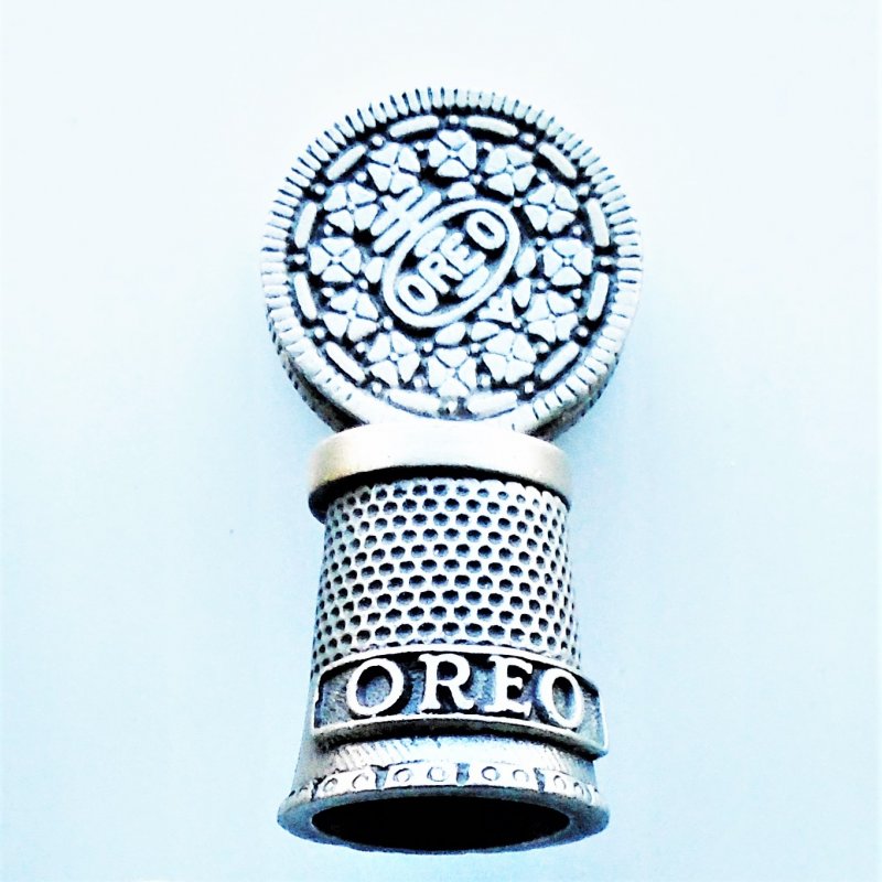 Collectible pewter thimble with an Oreo Cookie on top.