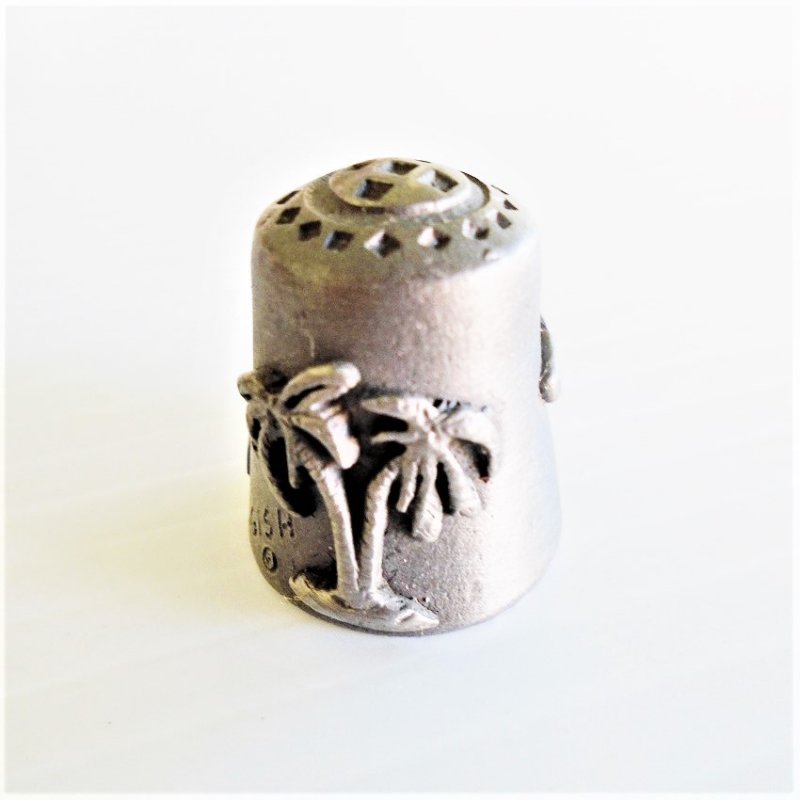 Collectible souvenir pewter thimble for the state of Florida. Signed Gish (for Nicholas Gish). 1 inch tall. Pelican, palm tree. Unknown age.